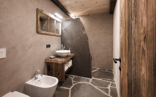 a bathroom with a sink and a toilet and a sink at Huberhof in Fiè