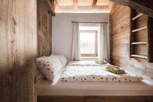 a bedroom with a bed and a window at Huberhof in Fiè