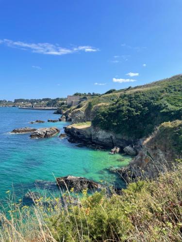 a view of the ocean from a bluff at Nid cosy au cœur de Palais in Le Palais