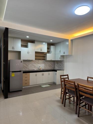 a kitchen and dining room with a table and chairs at C7 Hotel with beach front access in Iloilo City