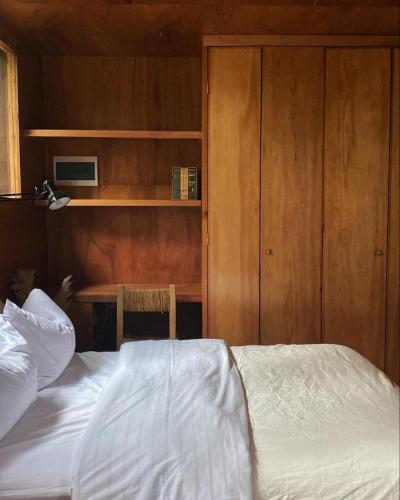 a bedroom with a bed and a desk with a computer at CASA LOBO - La Pedrera -Luxury- Diseño junto al Mar in La Pedrera