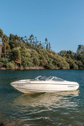 a white boat in the water on a lake at Alma-Rio Room 3 by Mycelia in Tomar
