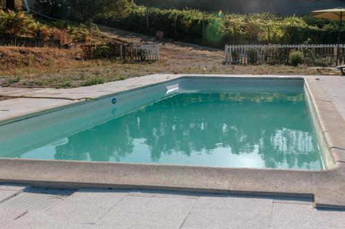 a swimming pool in a yard with the water at Alma-Rio Room 3 by Mycelia in Tomar