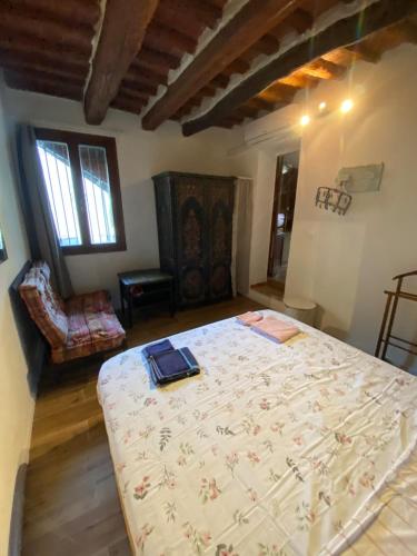 a bedroom with a large bed in a room at Rustichello G&P Tuscany in Lorenzana