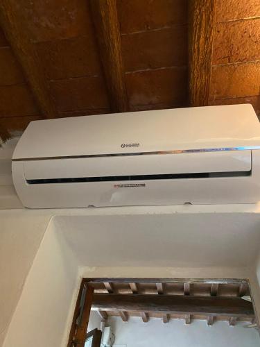 a white printer sitting on top of a refrigerator at Rustichello G&P Tuscany in Lorenzana