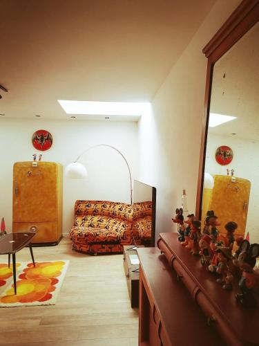 a living room with a mirror and a couch at Unique renovated chapel in Temse