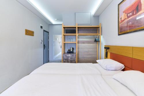 a bedroom with a large bed and a wooden headboard at Hotel Erika in Alexandroupoli