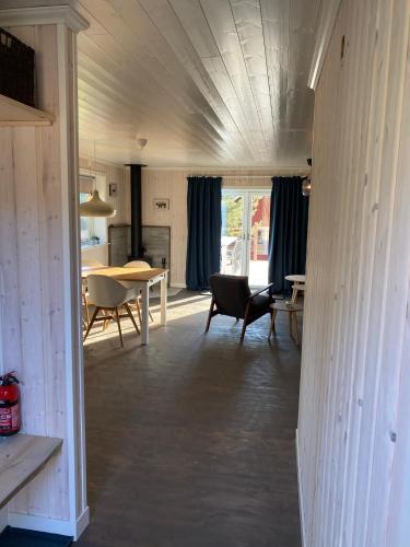 a living room with a table and a dining room at Adventure Guesthouse Sweden in rural area Sunne in Sunne