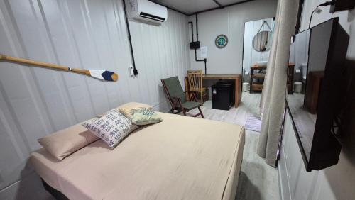 a hospital room with a couch with pillows on it at Aldeia Mar in Bertioga