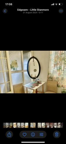 a picture of a room with a mirror and a table at F&D Cozy Corners in Edgware
