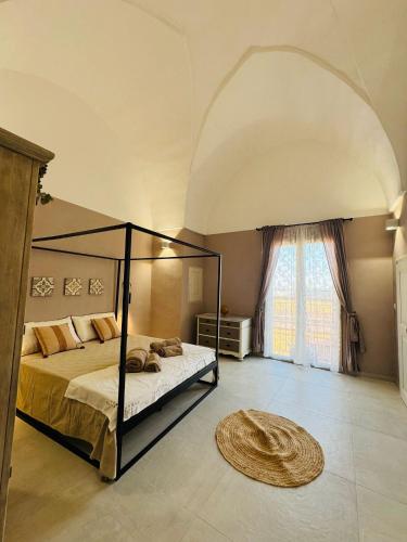 a bedroom with a bed and a large window at Relais Filomarino casa vacanze in Corsano