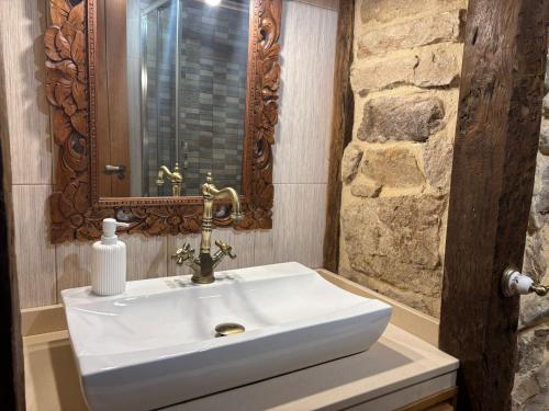 a bathroom with a white sink and a mirror at El Limonero in Arenas de Iguña