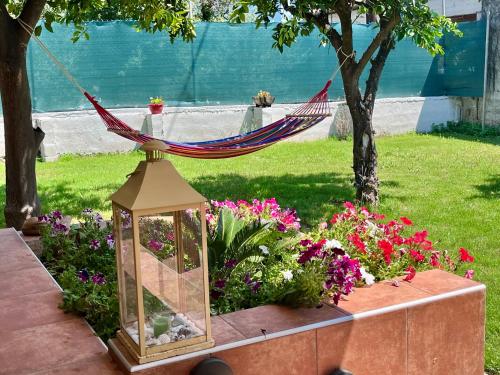 a hammock in a garden with flowers at Pelion Malaki- Casa Verde in Malaki