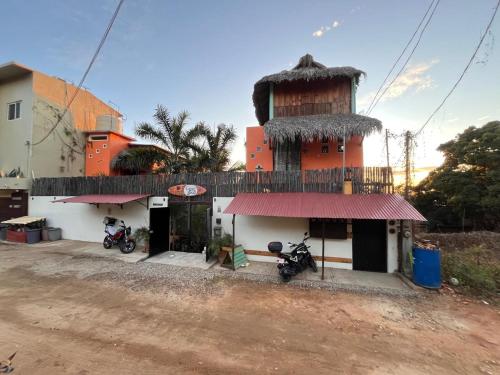 a building with two motorcycles parked in front of it at Casa Gio Paraiso Escondido in Puerto Escondido