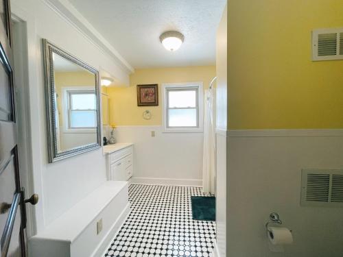a bathroom with a sink and a mirror at Victorian Home in Original Grandeur Downtown in Kokomo