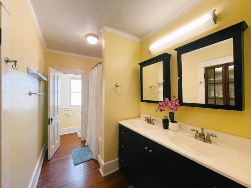 a bathroom with a sink and a mirror at Victorian Home in Original Grandeur Downtown in Kokomo