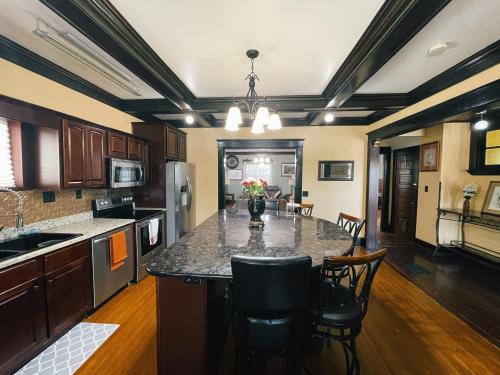 a kitchen with a large island in the middle at Victorian Home in Original Grandeur Downtown in Kokomo