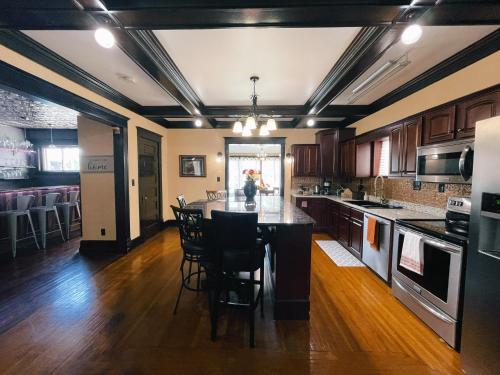 a kitchen with a large island in the middle at Victorian Home in Original Grandeur Downtown in Kokomo