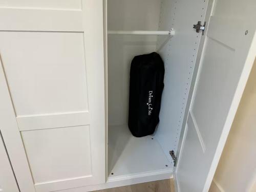 a black bag is sitting inside of a closet at Modern LuxeDen with Private Hot Tub and Fenced Yard in Lehi