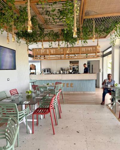 a restaurant with tables and chairs and a bar at Airy 1BR Pool and Beach Retreat in San Pedro de Macorís