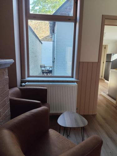 a living room with a large window and a couch at vakantiewoning 't Rijhuys in Diksmuide