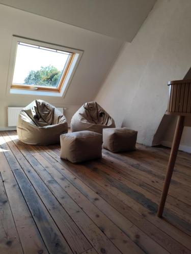 a room with three pillows on the floor with a window at vakantiewoning 't Rijhuys in Diksmuide