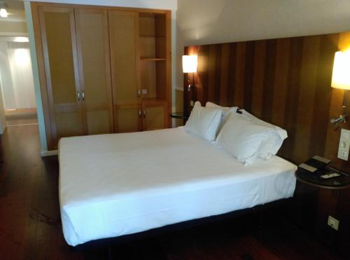 Кровать или кровати в номере Hotel Nuevo Portil Golf