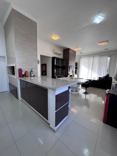 a large kitchen with a large island in a living room at Carlos Hanauer in Osório