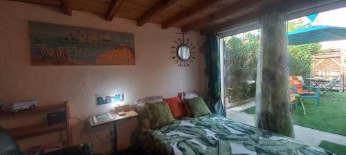 a bedroom with a bed and a large window at Studio Nature et Beauregard 30m2 en duplex proche lac, cures thermales et commerces in Saint-Paul-lès-Dax