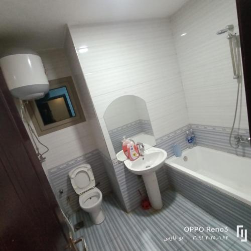 a bathroom with a sink and a toilet and a tub at Aswan mallblaza in Aswān