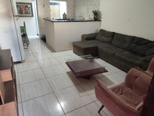 a living room with a couch and a coffee table at Repouso Alegre in Araguari