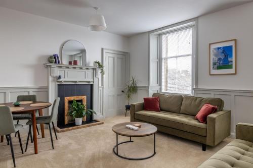 a living room with a couch and a table at Antonine Quarters in Grahamston