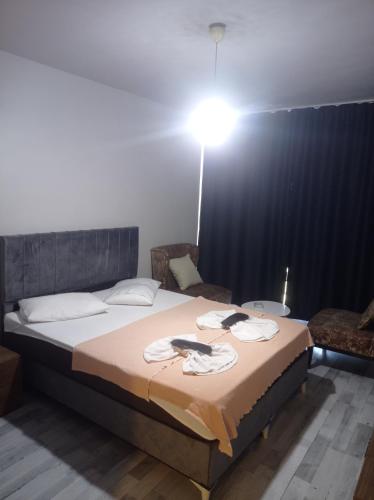 a bedroom with a bed with a light on it at FUAR Home in Esenyurt