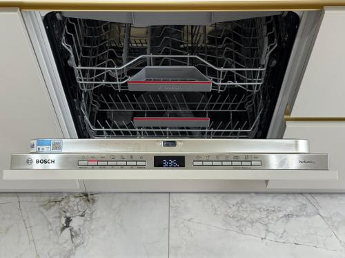 an open dishwasher with two devices inside of it at CASHMERE Apartment - Airport Katowice-Pyrzowice in Siewierz