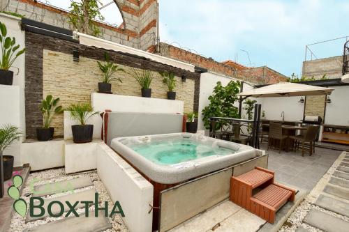 a jacuzzi tub on the patio of a building at Casa Boxtha in Ixmiquilpan