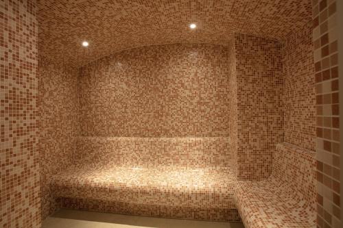 a tiled bathroom with a tub in a room at Sunset Jeddah in Jeddah