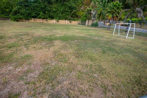 a large grass field with a soccer goal in it at Sunset Sea-renity Villa in Belle Air Summit