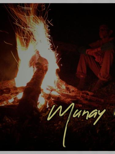 a picture of a person sitting next to a fire at MUNAY, Posada rural para el sosiego in Alcalá