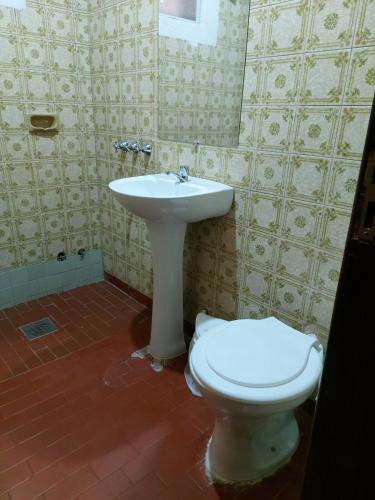 a bathroom with a toilet and a sink at Encarnacion House in Encarnación