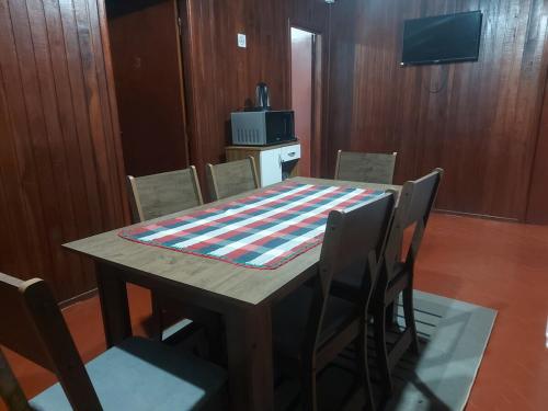 a table with chairs and a blanket on top of it at Encarnacion House in Encarnación