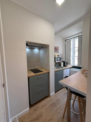 a kitchen with a counter and a table in it at Alfama Dream Apartments in Lisbon