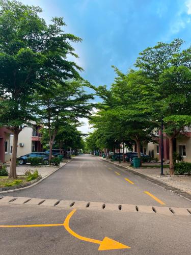 an empty street with a yellow arrow on the road at Kind Maisonettes Apartments in Abuja