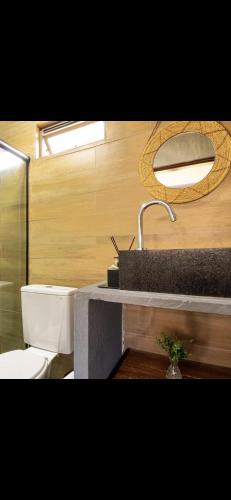 a bathroom with a sink and a toilet at Casa Zouk, charme e alto padrão in Japaratinga