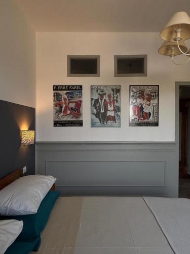 a bedroom with posters on the wall and a bed at La Pausa in Portoferraio
