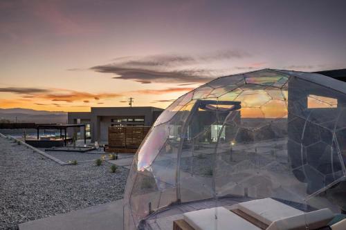 a glass dome with a sunset in the background at Pool-Pickleball-YogaDeck in Joshua Tree