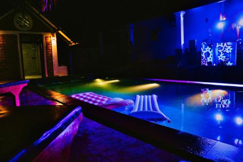 a pool table with two cues on it at night at SAMA KAMI Ayurvedic Resort & Villa in Polatupalata