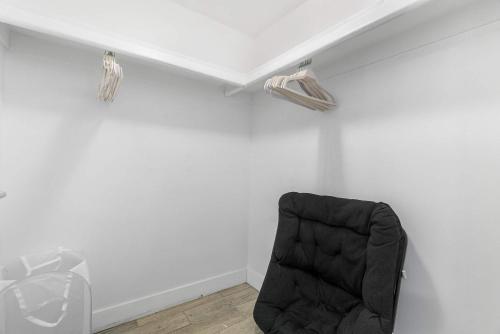 a room with a black chair in a white wall at Tempe Room Private Bath Walk to ASU & Mill in Tempe