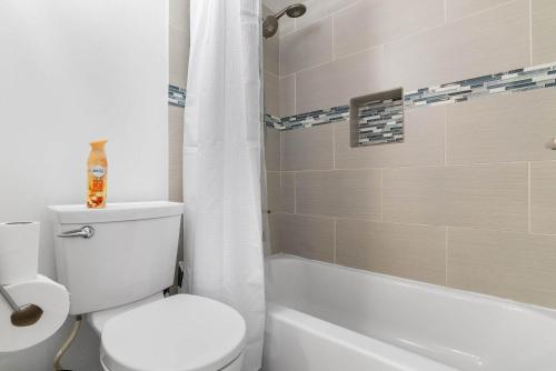 a bathroom with a toilet and a tub and a shower at Tempe Room Private Bath Walk to ASU & Mill in Tempe