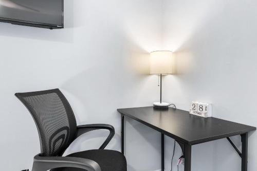 a room with a table and a chair and a lamp at Tempe Room Private Bath Walk to ASU & Mill in Tempe