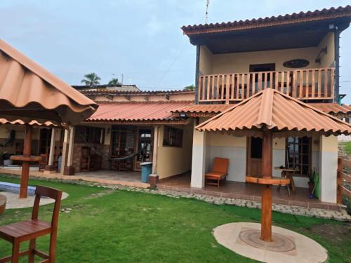 a house with a roof with a grass yard at Villas Caracol in Las Tablas